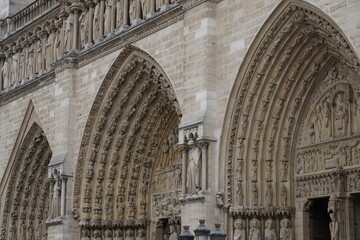 closeup of old notre dame stone intricate entrance in paris france