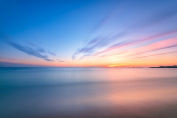 Fototapeta na wymiar Tranquil Sunrise Sunset Long Exposure over water with beautiful gentle colors.