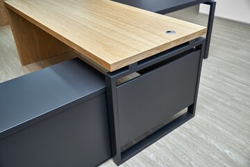 Large executive desk made of oak timber veneer with dark grey enamel in trendy minimal style stands...