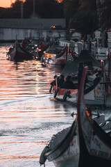 Sunset photography in Aveiro, with boats passing in the background