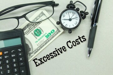 pens, calculators, glasses and banknotes with the words excessive costs