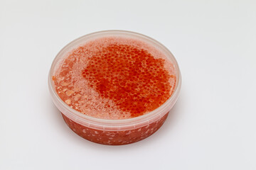 closed plastic jar with natural frozen caviar