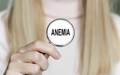 ANEMIA text on a stethoscope in the hands of a female doctor