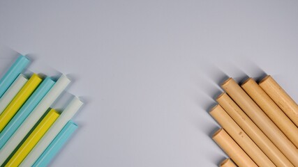 Plastic straws juxtaposed with bamboo straws