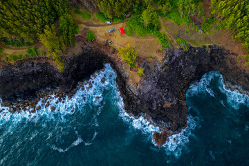 Aerial view of waves crashing against cliffs near Andrea lodges during sunset in the south coast of Mauritius island