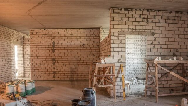 Builders laying brick walls inside appartment with professional timelapse.
