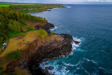 Aerial view of waves crashing against cliffs near Andrea lodges during sunset in the south coast of Mauritius island