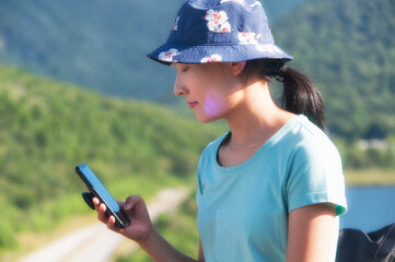 chinese woman looking at her mobile phone