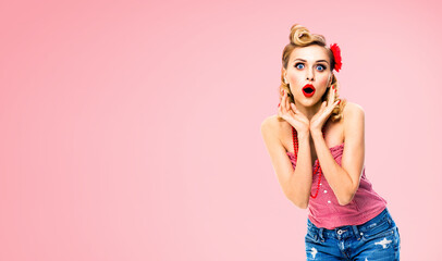 Unbelievable news! Excited surprised, very happy blondy hair woman. Pin up style girl with open mouth and raised hands. Retro and vintage concept. Rose pink background.