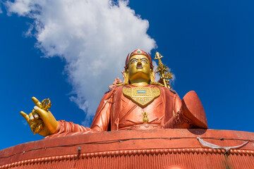 Samdruptse statue , a huge buddhist memorial statue in Sikkim, blue cloudy sky in background. It is a fourite tourist spot in Sikkim.