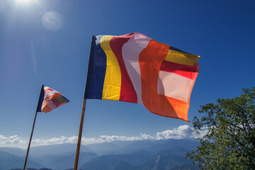Colurful Buddhist Prayer flags are waving in strong wind under sunshine at Samdruptse, huge buddhist memorial Monastery in Sikkim, India.