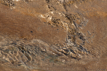 Sunrays reflecting from stones and rocks underwater - creating beautiful abstract natural pattern. Image shot at Reshi river, Sikkim, India