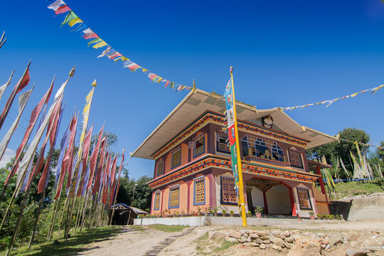 Gurung monastery - a beautiful sunlit Buddhist Monastery at Rinchenpong, Sikkim , India. Blue clear sky above and Buddhist prayer flags around.