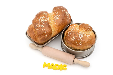 fresh baked Traditional Romanian homemade sweet bread with Wooden rolling pin and word magic on white background