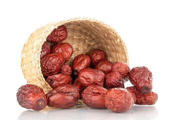 Several dried ziziphus berries with straw dishes, close-up, isolated on white.