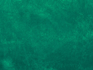 Dark green old velvet fabric texture used as background. Empty green fabric background of soft and smooth textile material. There is space for text....