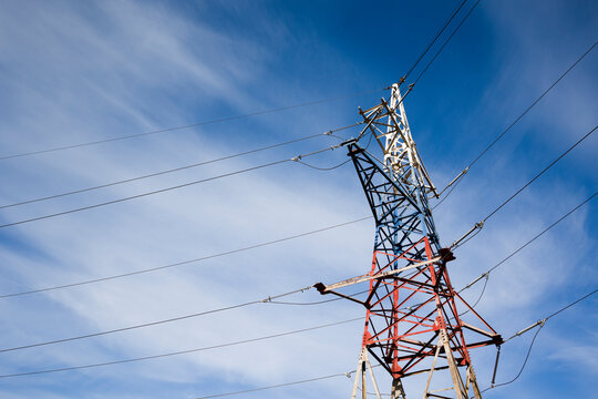 High-voltage electrical  line against the blue sky.