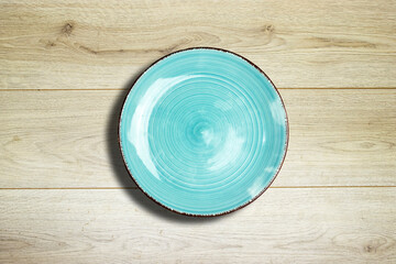Empty ceramic blue plate on wooden planks table