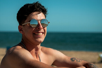 person on the beach with sunglasses