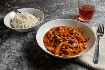 Red chicken curry with basmati rice. Chicken tikka masala.