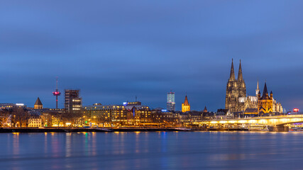 Fototapeta na wymiar Illuminated historical buildings against Cologne winter skyline
