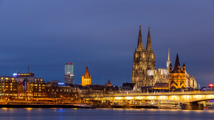 Fototapeta na wymiar Illuminated historical buildings against Cologne winter skyline
