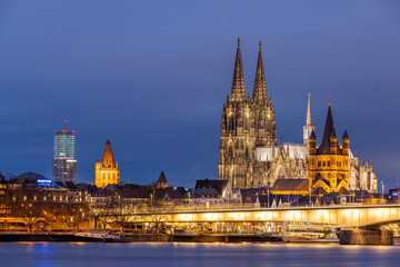 Illuminated historical buildings against Cologne winter skyline