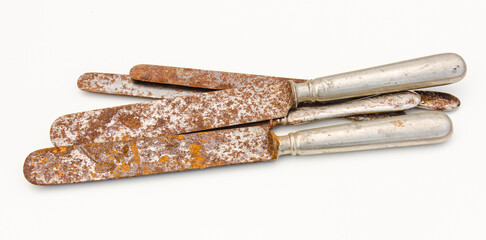 Rusted old knives on white background, close up