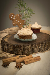 Smiling gingerbread man cookie on a gingerbread cupcake.