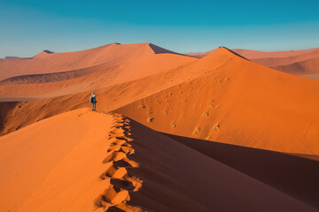 Fototapeta na wymiar Tourist photographs dunes of Sossusvlei, Namibia, Africa