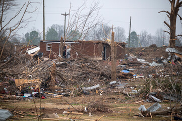 Destroyed neighborhood devastated by tornado with scattered debris