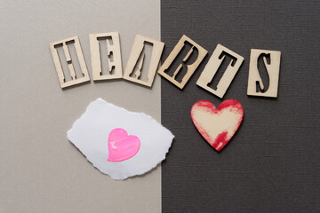 the word "hearts" and two hand painted hearts on paper