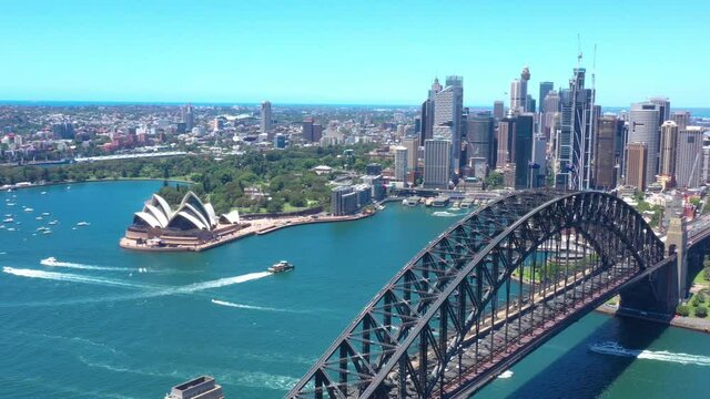 Aerial drone flyover above Sydney Harbour Bridge on a beautiful sunny day 