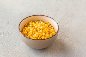 Canned sweet corn in  bowl.