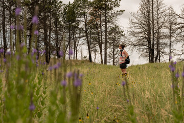 Woman Looks out over prairie through wildflowers