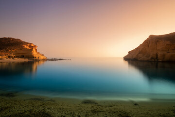 
Sunset on the beach of Cocedores between the Region of Murcia and Andalusia, in Spain. A beach with crystal clear waters and calm greenish blue that invites calm and reflection.