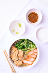 Noodles soup with wonton dumpling and grilled red pork, Asian food, Top view