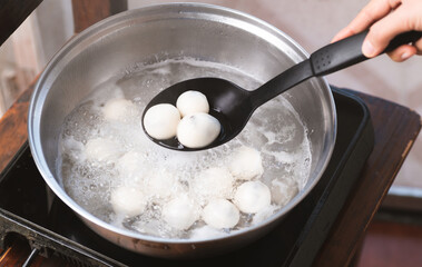 Hand making Tangyuan, Chinese dessert made of ball glutinous rice flour in boiled water