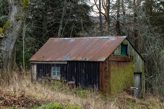 BALLINDALLOCH, MORAY, SCOTLAND - 30 DECEMBER 2021: This is a a very old wooden building used for storage in Ballindalloch, Moray, Scotland on 30 December 2021..