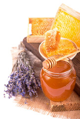 glass pot with floral honey and a bouquet of lavender isolated on white background