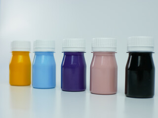 pigment resin paint in the bottle, many colors there are purple, pink, blue, orange, and black.