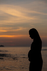 silhouette of a person sitting on a bench, sunset over the river, Patong beach