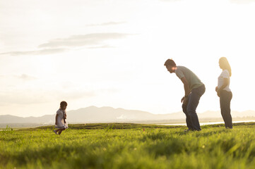 Happy family on summer Mother, father and daughters in the meadow