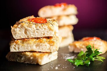Fresh baked focaccia with cherry tomato, poppy and sesame seeds, pepper, Himalayan rock salt and mixed herbs. 
