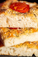 Fresh baked focaccia with cherry tomato, poppy and sesame seeds, pepper, Himalayan rock salt and mixed herbs. 