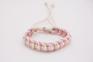 An isolated ethnic bracelet on white background. The bracelet is made off the various rope