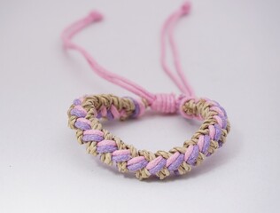 An isolated ethnic bracelet on white background. The bracelet is made off the various rope