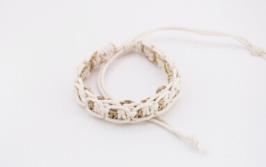 An isolated ethnic bracelet on white background. The bracelet is made off the various rope