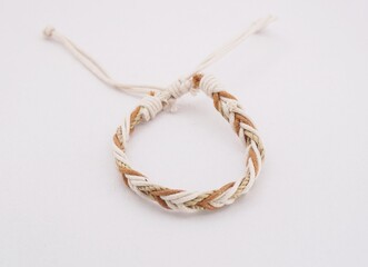 An isolated ethnic bracelet on white background. The bracelet is made off the various rope
