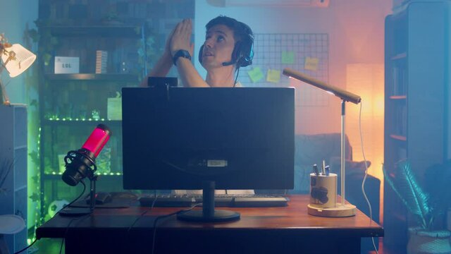 Young gamer man praying on pc at home